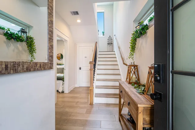a view of entryway and hall with wooden floor