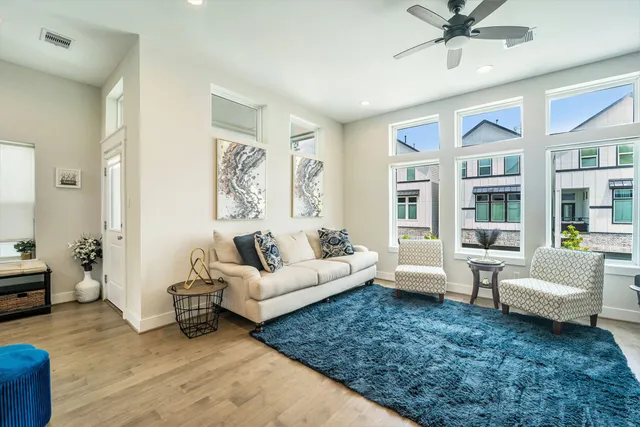 a living room with furniture and wooden floor