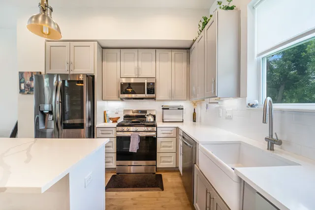 a kitchen with a sink a stove a refrigerator and a sink