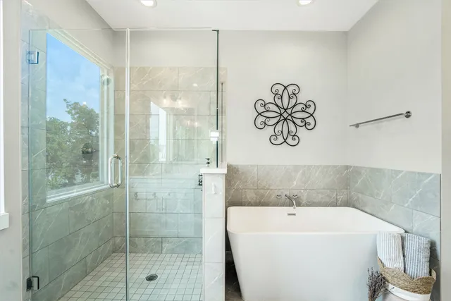 a bathroom with a bathtub and a shower