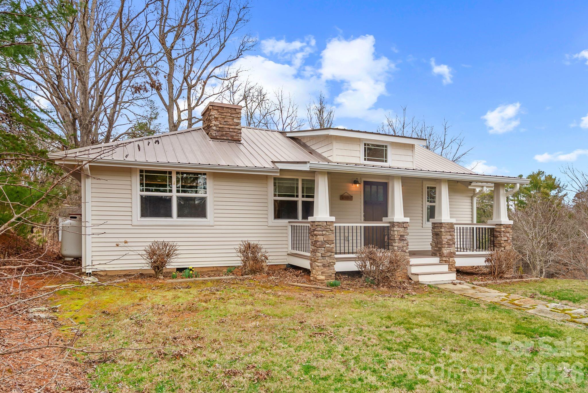 a front view of a house with yard porch and outdoor seating