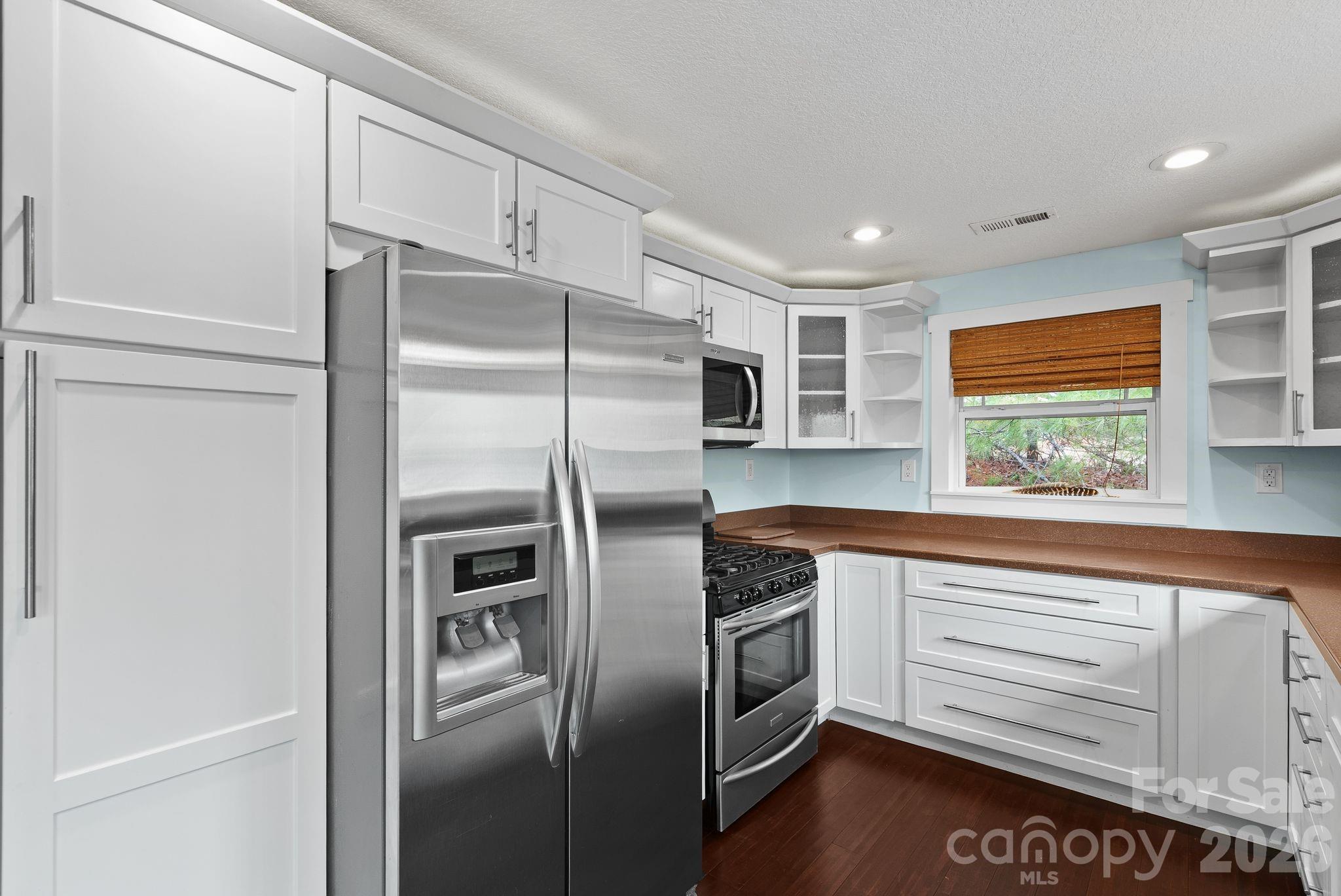 90 Palmer Ford Road Weaverville, NC 28787 - Photo 11 of 32 a kitchen with stainless steel appliances a refrigerator sink and microwave