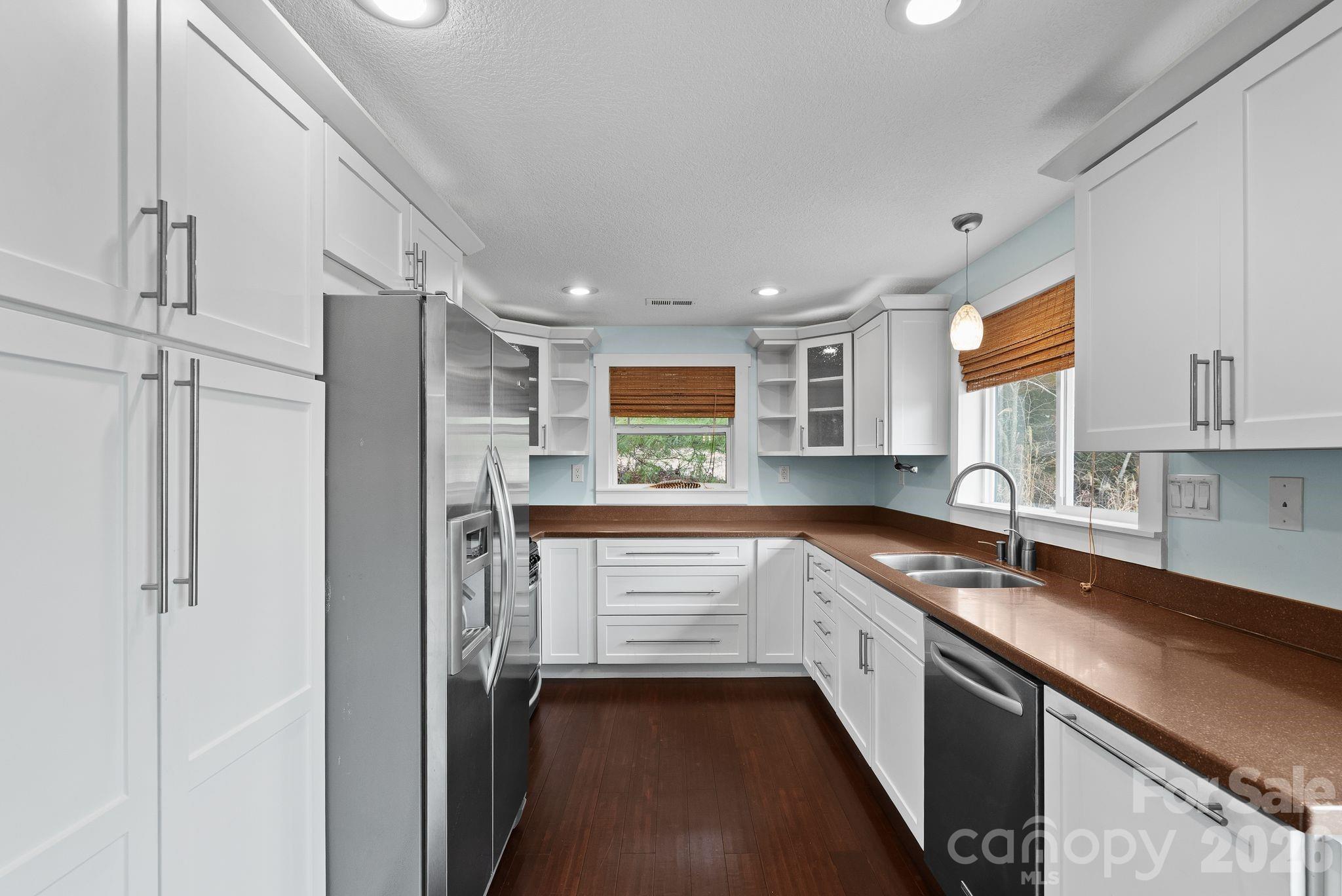 90 Palmer Ford Road Weaverville, NC 28787 - Photo 12 of 32 a kitchen with a sink dishwasher a refrigerator and cabinets