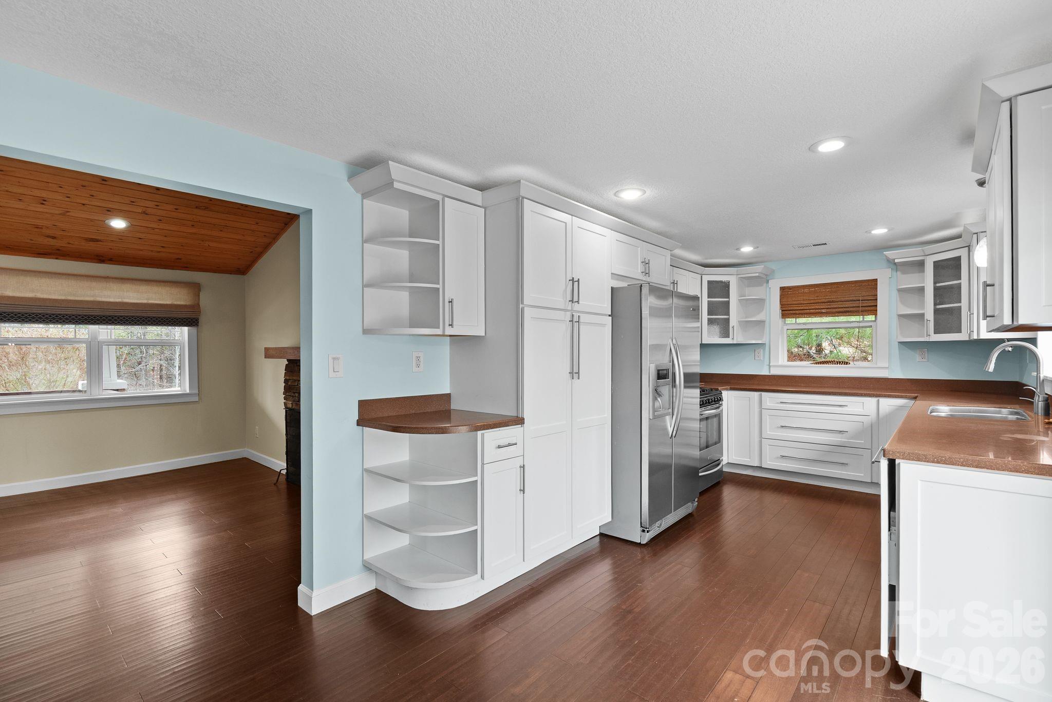 90 Palmer Ford Road Weaverville, NC 28787 - Photo 13 of 32 a kitchen with stainless steel appliances wooden floor and a refrigerator