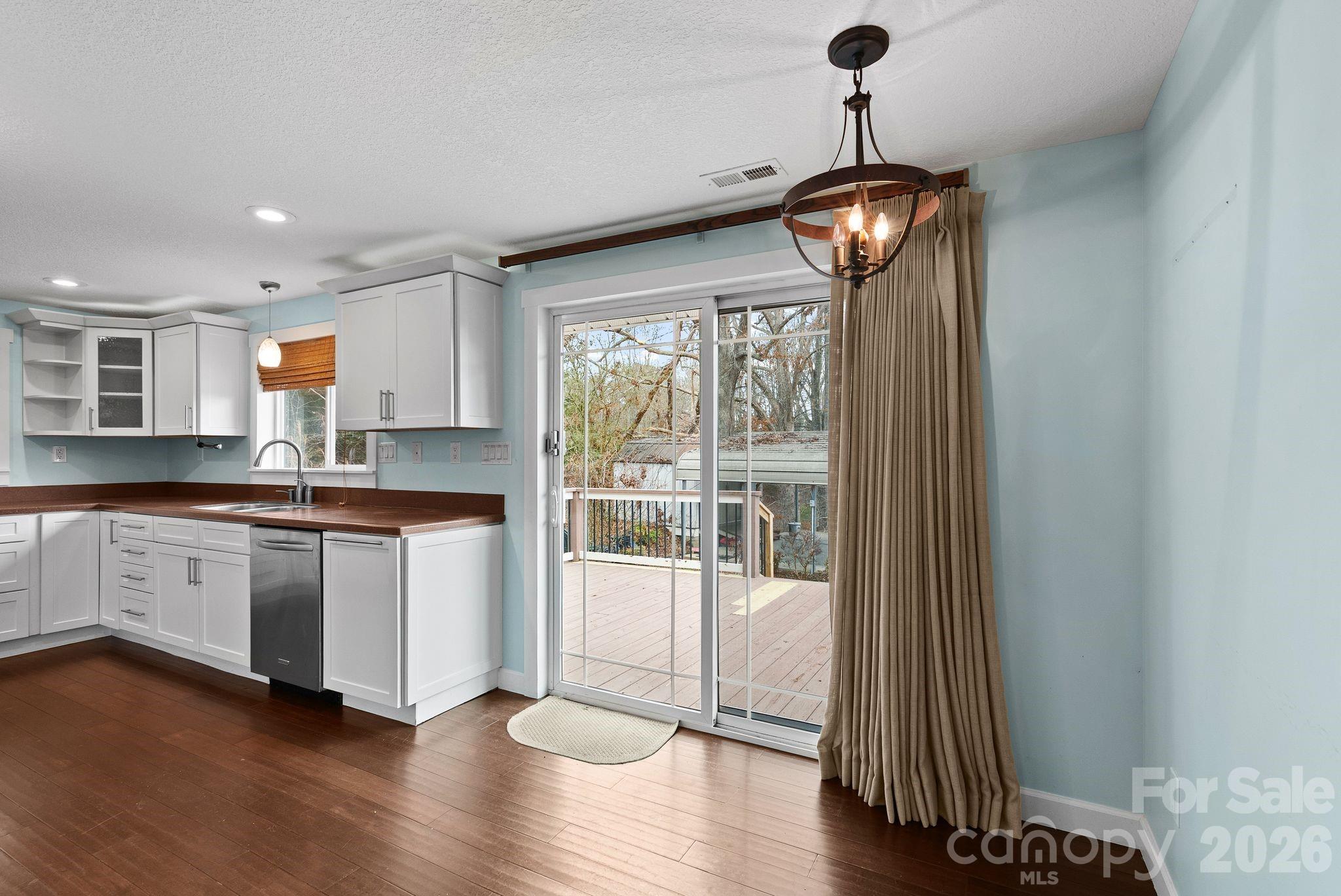 90 Palmer Ford Road Weaverville, NC 28787 - Photo 14 of 32 a kitchen with granite countertop a stove and a wooden floors