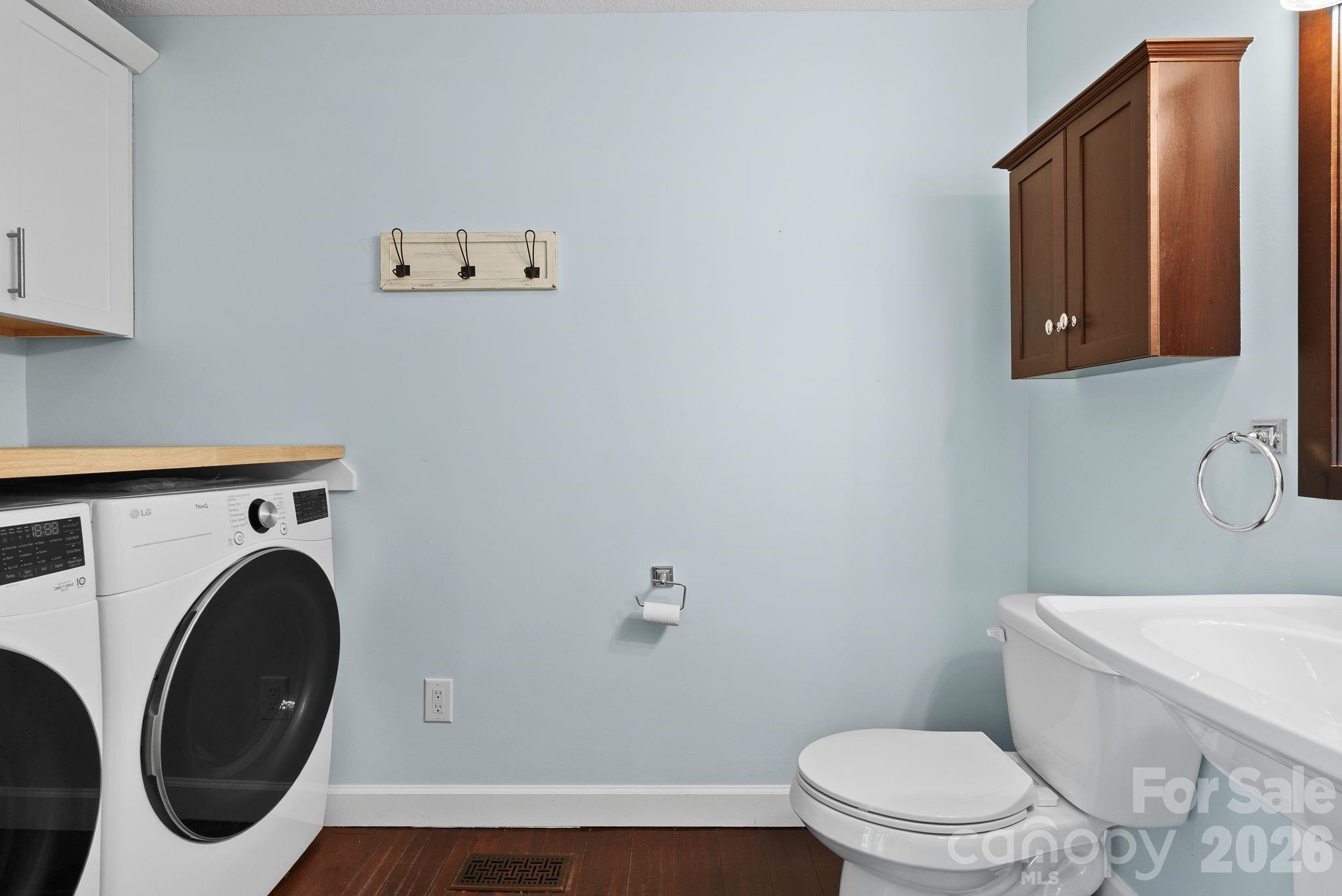 90 Palmer Ford Road Weaverville, NC 28787 - Photo 17 of 32 a white toilet sitting next to a bathroom sink and vanity