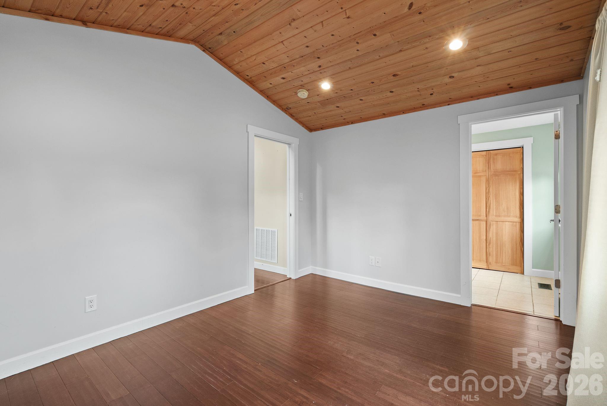 90 Palmer Ford Road Weaverville, NC 28787 - Photo 20 of 32 an empty room with wooden floor and windows
