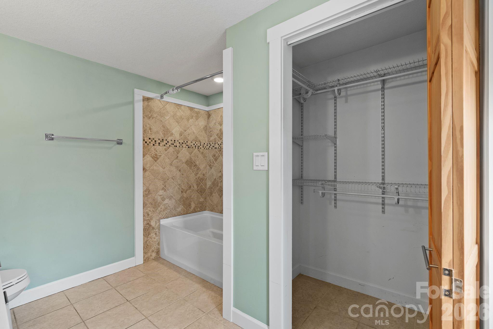 90 Palmer Ford Road Weaverville, NC 28787 - Photo 22 of 32 a bathroom with a bathtub and shower