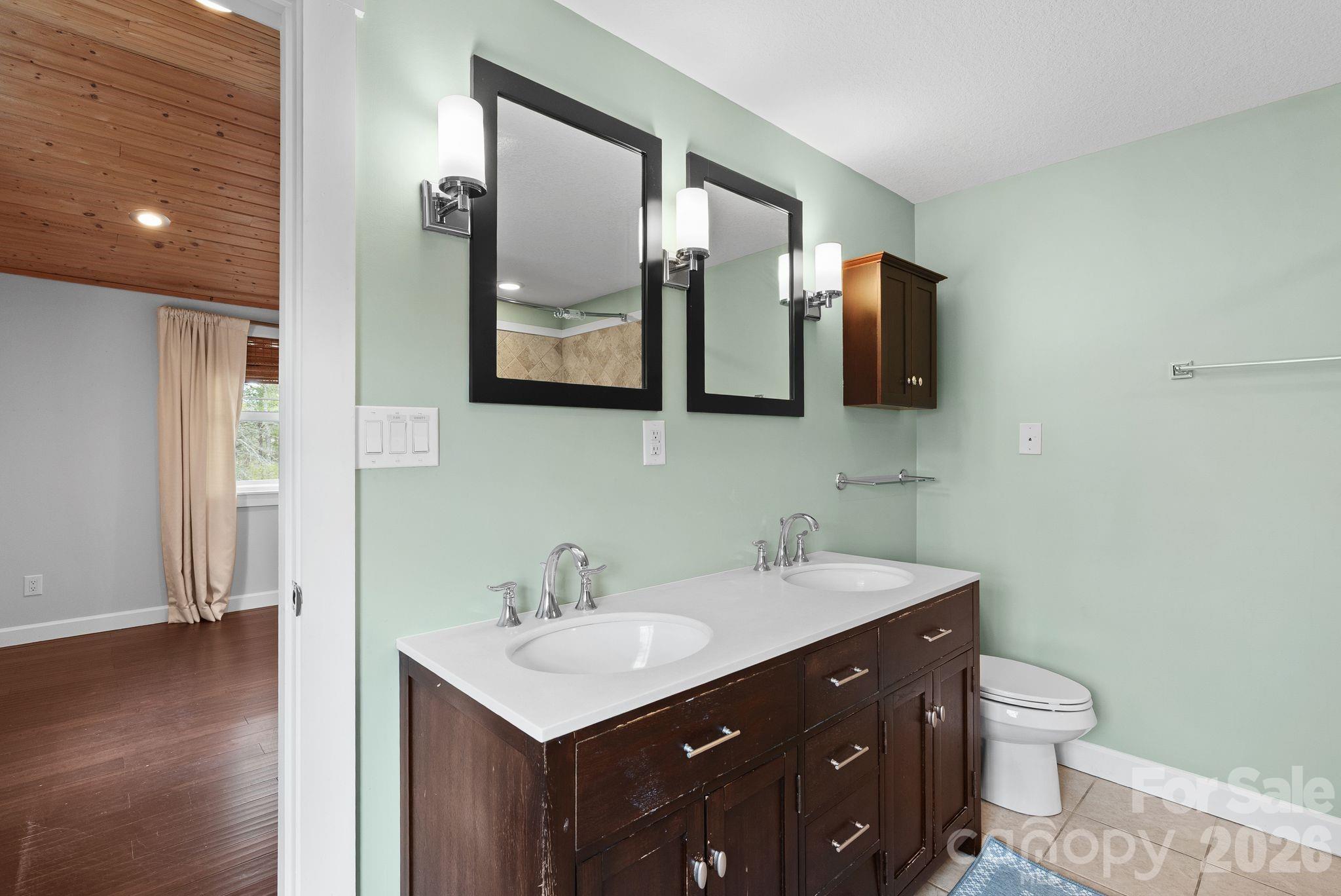 90 Palmer Ford Road Weaverville, NC 28787 - Photo 23 of 32 a bathroom with a double vanity sink and mirror