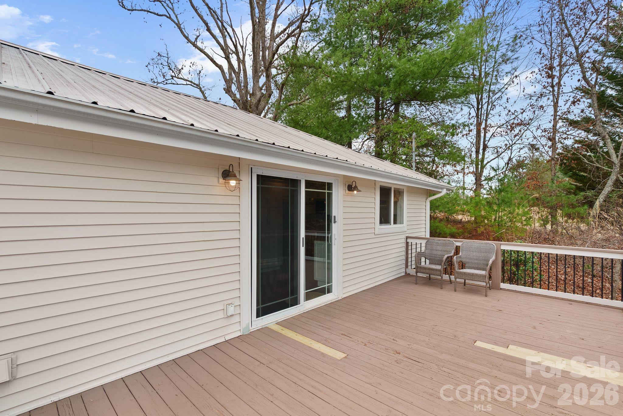 90 Palmer Ford Road Weaverville, NC 28787 - Photo 27 of 32 a view of a white house with a wooden bench next to a road