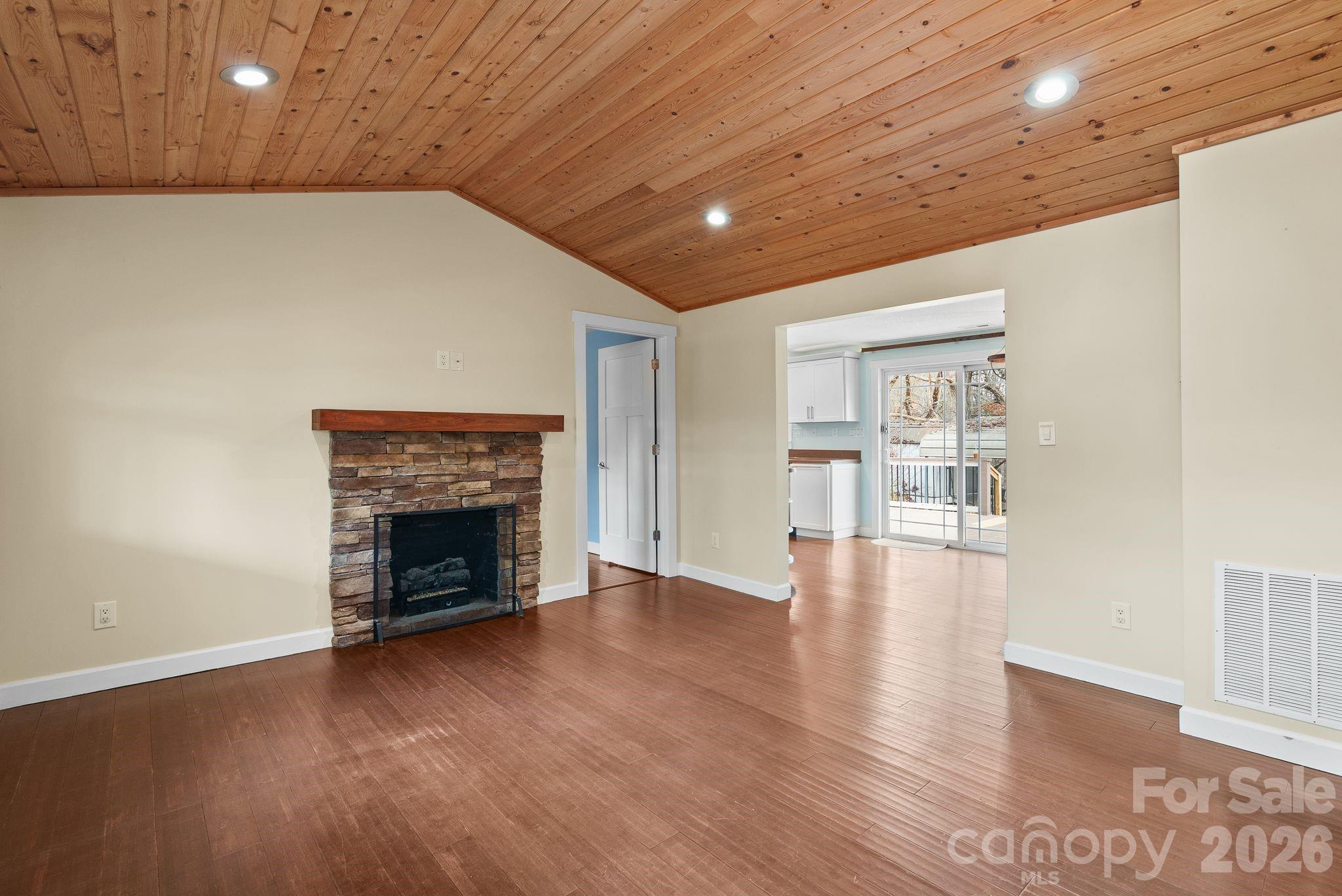 90 Palmer Ford Road Weaverville, NC 28787 - Photo 8 of 32 a view of an empty room with wooden floor fireplace and a window