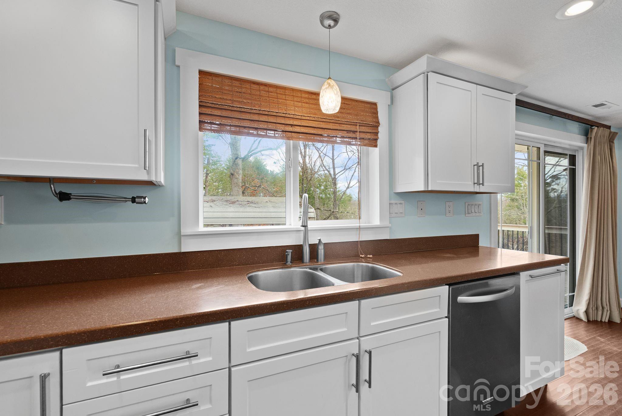 90 Palmer Ford Road Weaverville, NC 28787 - Photo 9 of 32 a kitchen with granite countertop a sink and white cabinets