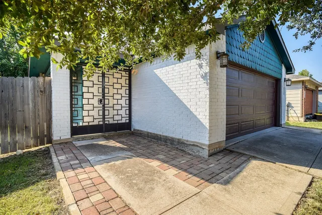 a view of backyard with a barn and a large tree