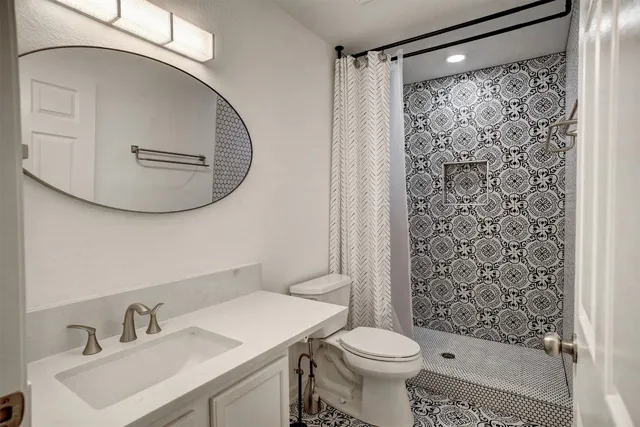 a bathroom with a sink toilet and shower