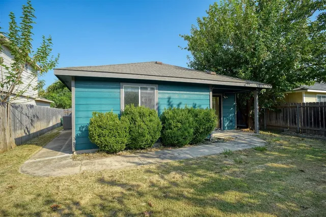 a front view of a house with a garden