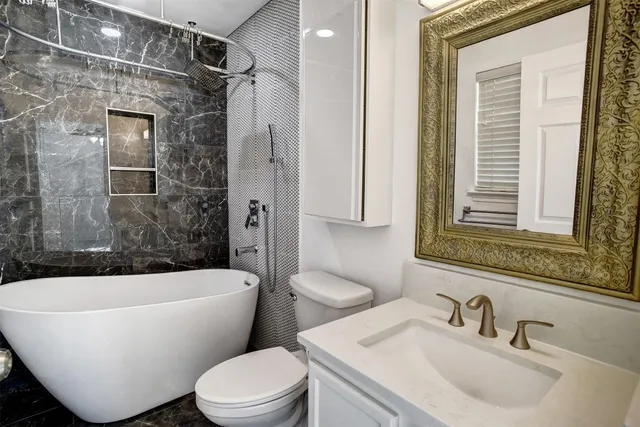 a bathroom with a sink toilet bathtub and shower