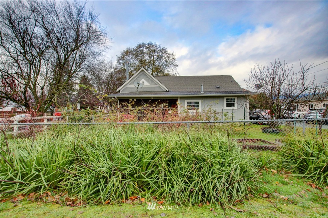 910 Cook Road Sedro-Woolley, WA 98284 - Photo 1 of 37 a front view of a house with a yard table and chairs