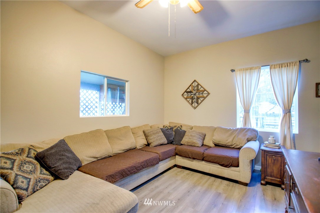 910 Cook Road Sedro-Woolley, WA 98284 - Photo 13 of 37 a living room with a couch and a wooden floor