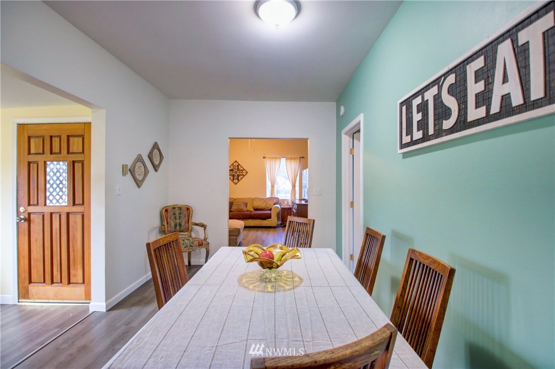 910 Cook Road Sedro-Woolley, WA 98284 - Photo 19 of 37 a view of a dining room with furniture window and wooden floor