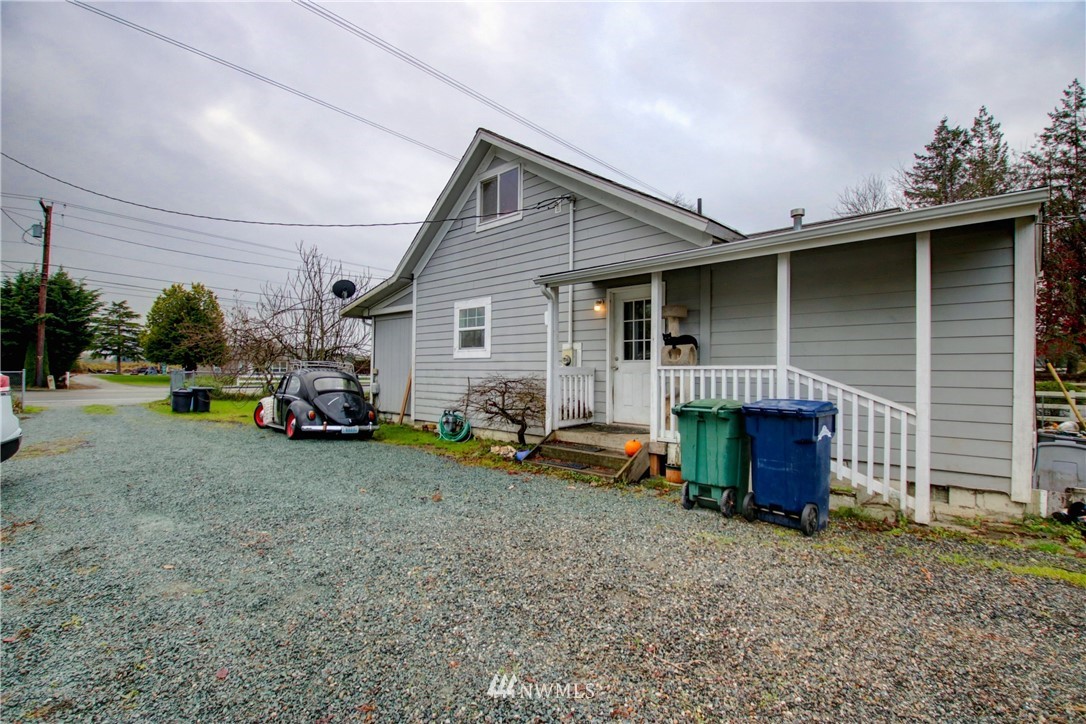 910 Cook Road Sedro-Woolley, WA 98284 - Photo 3 of 37 a view of a house with a patio and a yard