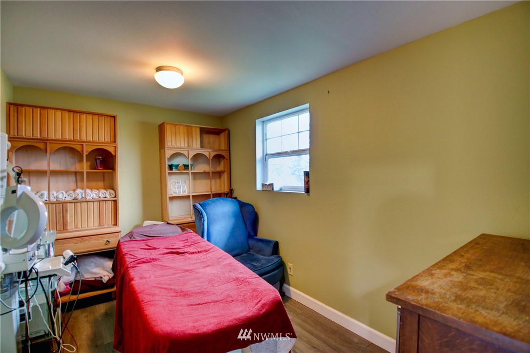 910 Cook Road Sedro-Woolley, WA 98284 - Photo 24 of 37 a bedroom with a bed and wooden floor