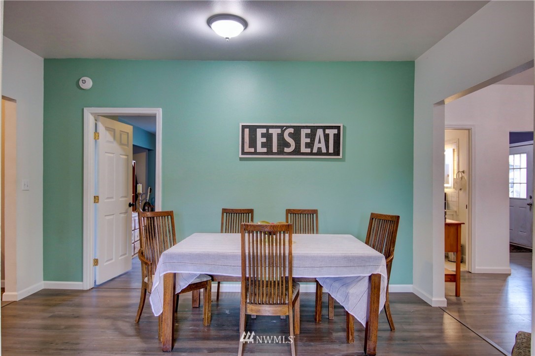 910 Cook Road Sedro-Woolley, WA 98284 - Photo 25 of 37 a view of a dining room with furniture wooden floor and a chandelier
