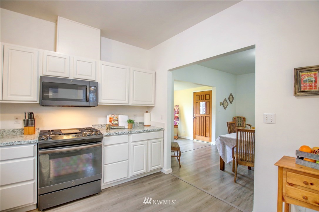 910 Cook Road Sedro-Woolley, WA 98284 - Photo 7 of 37 a kitchen with stainless steel appliances granite countertop a stove a sink and a microwave