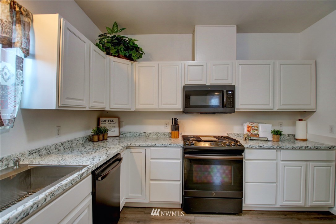 910 Cook Road Sedro-Woolley, WA 98284 - Photo 10 of 37 a kitchen with granite countertop white cabinets stainless steel appliances and a sink
