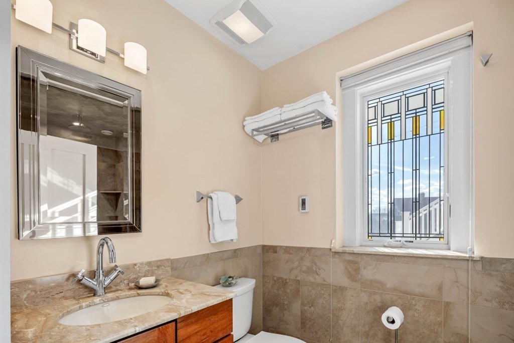 13 Beacon Road Hull, MA 02045 - Photo 28 of 41 a bathroom with a granite countertop sink mirror and vanity