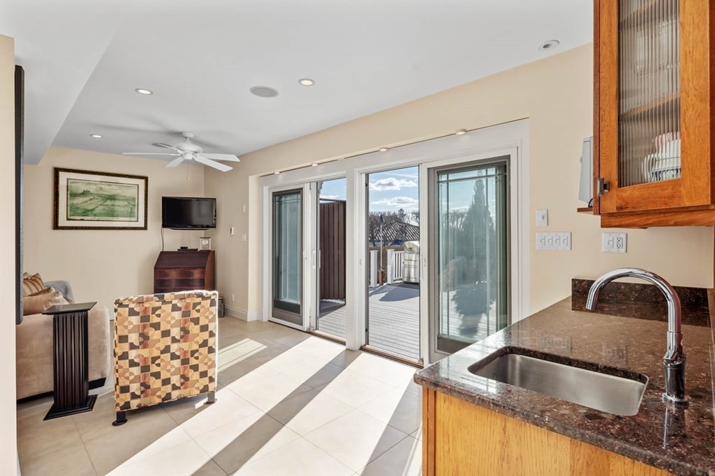 13 Beacon Road Hull, MA 02045 - Photo 31 of 41 a kitchen with granite countertop a sink and a refrigerator