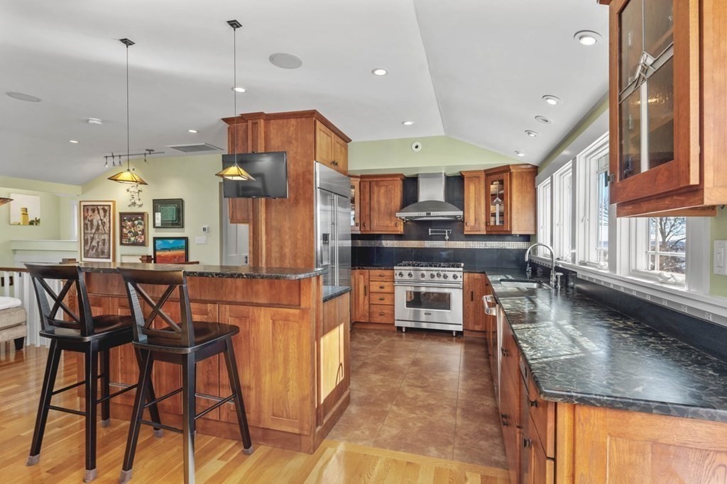 13 Beacon Road Hull, MA 02045 - Photo 7 of 41 a kitchen with stainless steel appliances granite countertop table chairs and a refrigerator