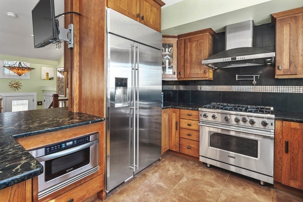 13 Beacon Road Hull, MA 02045 - Photo 8 of 41 a kitchen with stainless steel appliances granite countertop a stove and a refrigerator