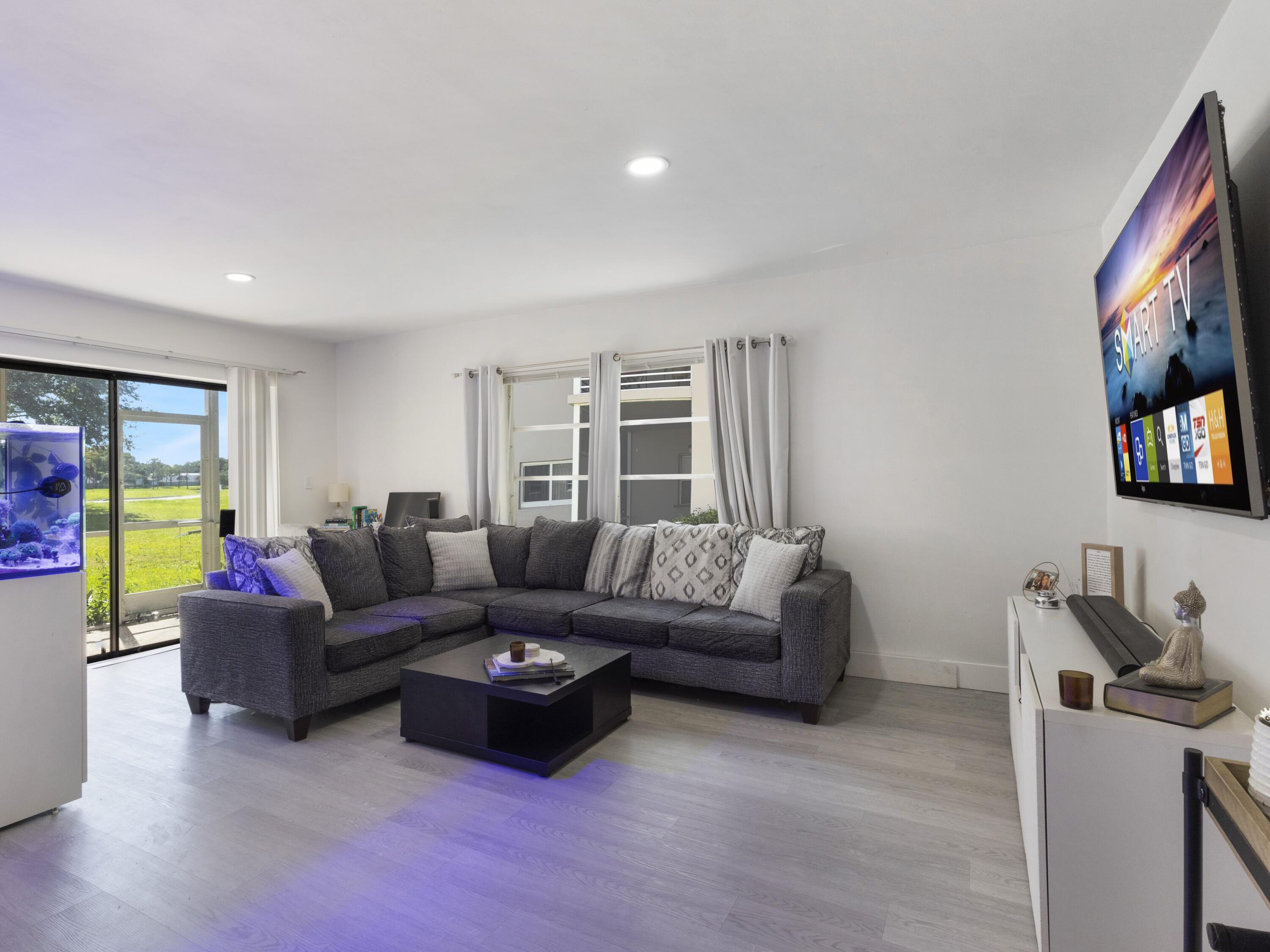 2430 Southwest 81st Avenue, Unit 108 Davie, FL 33324 - Photo 1 of 18 a living room with furniture and a flat screen tv