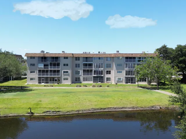 a view of a large building with a big yard and large trees