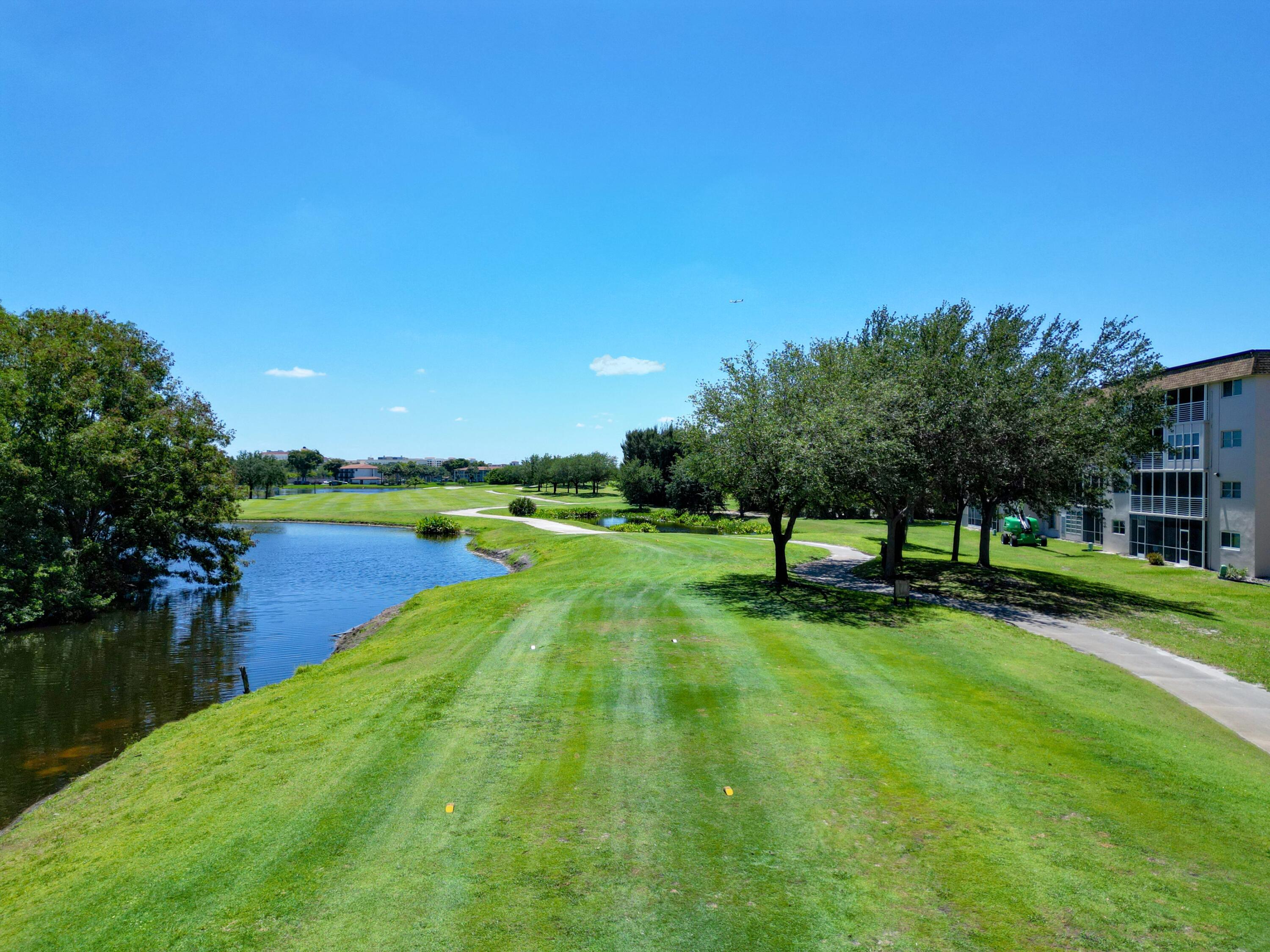 2430 Southwest 81st Avenue, Unit 108 Davie, FL 33324 - Photo 3 of 18 a view of a lake with a yard