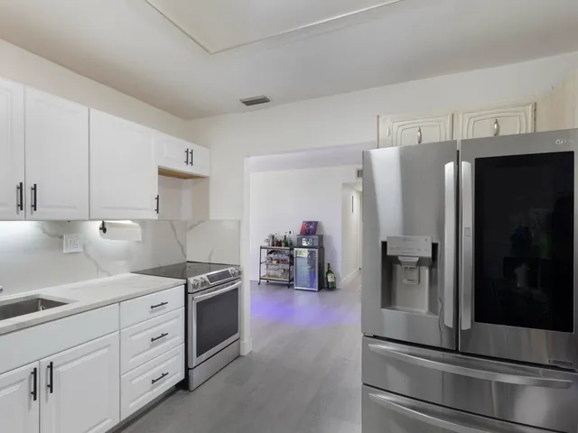 a kitchen with stainless steel appliances a refrigerator sink and stove