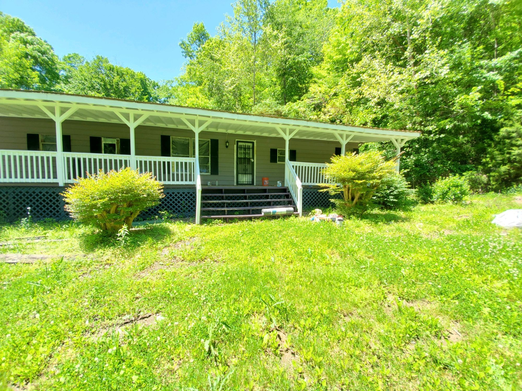 a view of a house with a yard and sitting area