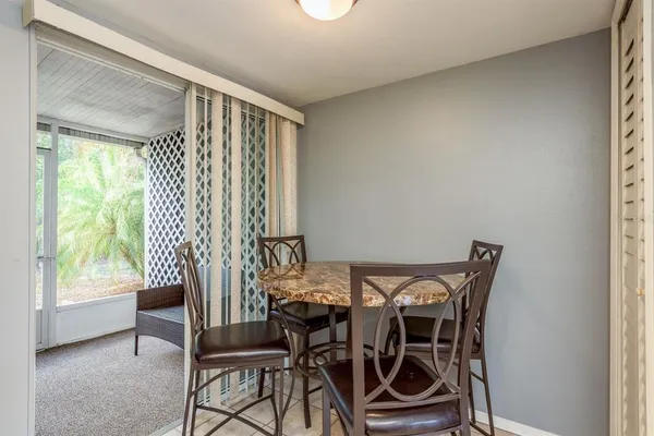 a view of a dining room with furniture and a window