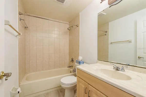 an empty room with a window and wooden floor