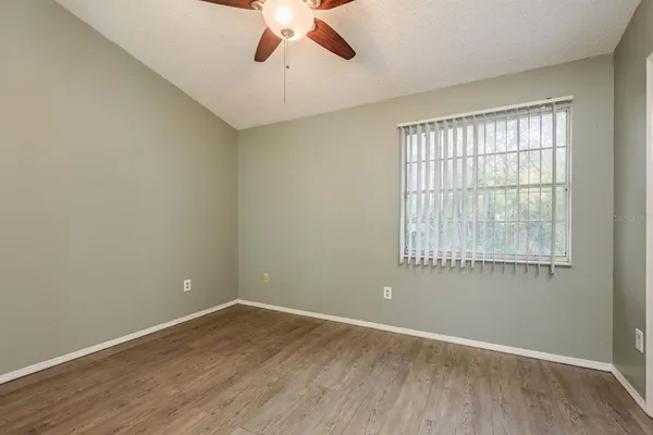 an empty room with a empty space and a ceiling fan