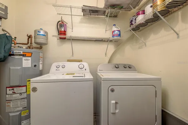 a view of a tables and chairs in back yard of the house