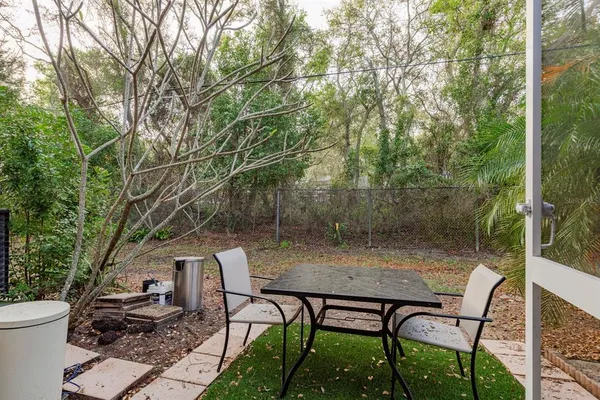 a view of a house with backyard and sitting area