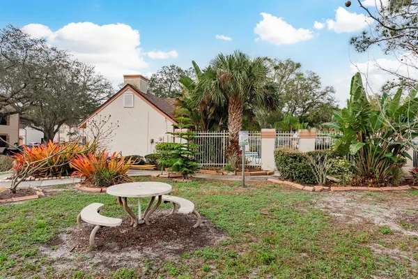 a view of swimming pool with outdoor seating and house in the background