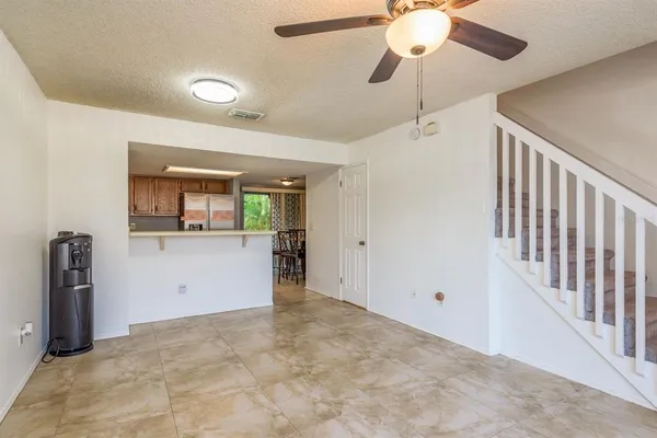a view of a kitchen with a sink and a chandelier fan
