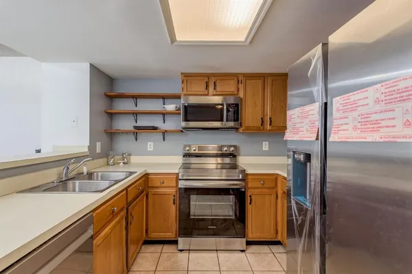 a kitchen with stainless steel appliances granite countertop a stove and a sink