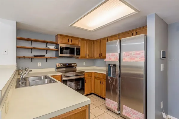 a kitchen with a refrigerator stove and a sink