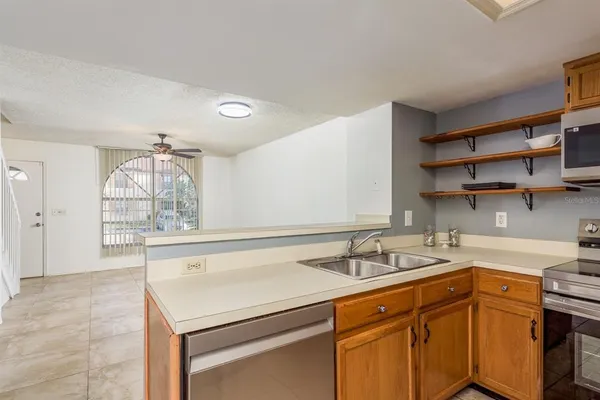 a kitchen with a sink cabinets and window