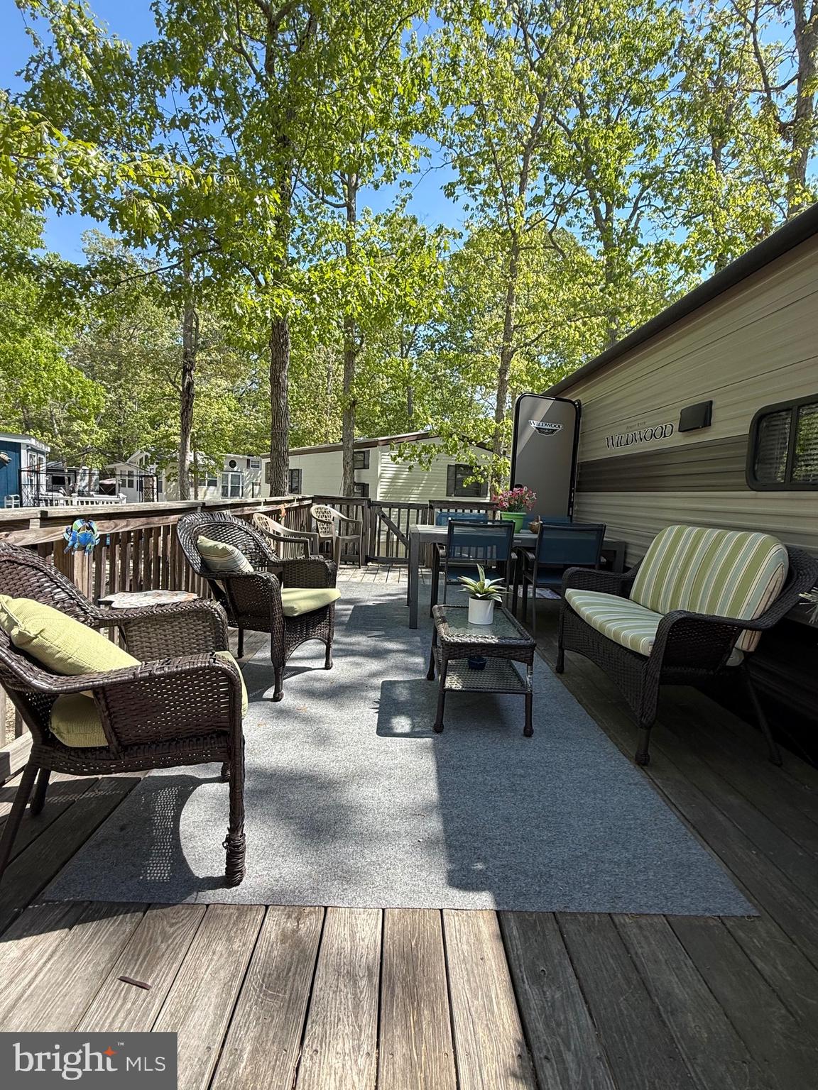 60 Corsons Tavern Road, Unit 342 Ocean View, NJ 08230 - Photo 18 of 19 a view of a patio with couches table and chairs and wooden floor