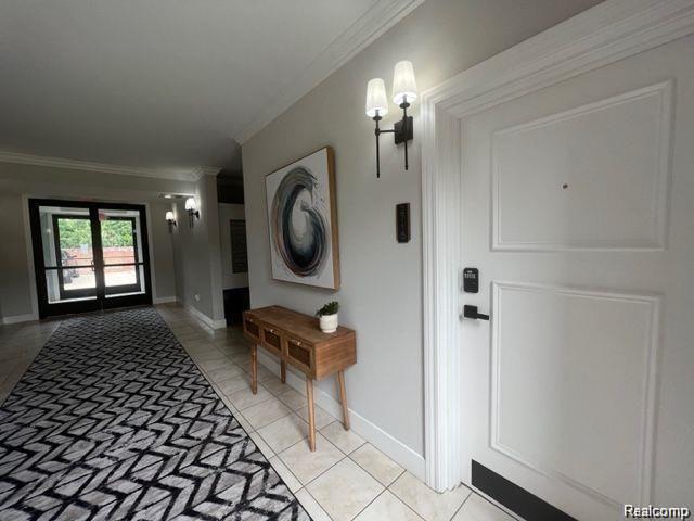 2727 East Maple Road Birmingham, MI 48009 - Photo 11 of 29 Tile flooring with neutral wall tones and crown molding
