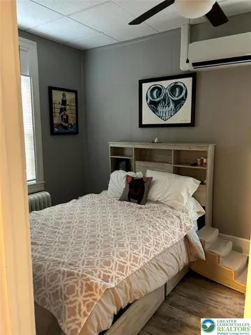 a bed sitting in a bedroom and painting on the wall